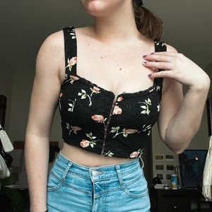 Black top with pink flowers and a hook front detail